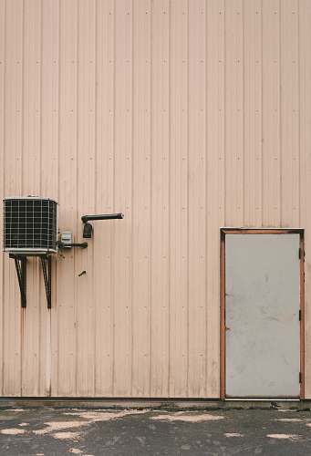wall gray air condenser beside gray closed door minerva